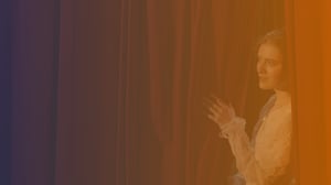 Performer behind stage curtain