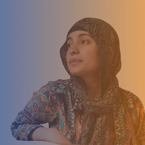 Early 20s Female wearing a headscarf is looking off to the side on blue to orange gradient background