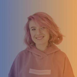 Early 20s white woman with pink hair wearing a pink hoodie