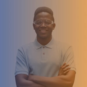 Late teens black male wearing safety glasses, blue t-shirt with his arms crossed