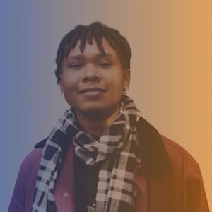 Mid 20s non-binary black person wearing a black and white scarf